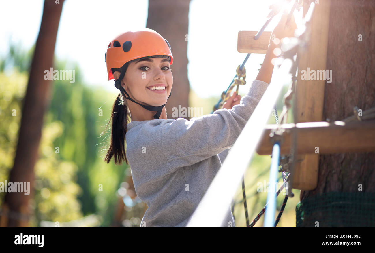 Beautiful emotional woman doing climbing activities Stock Photo