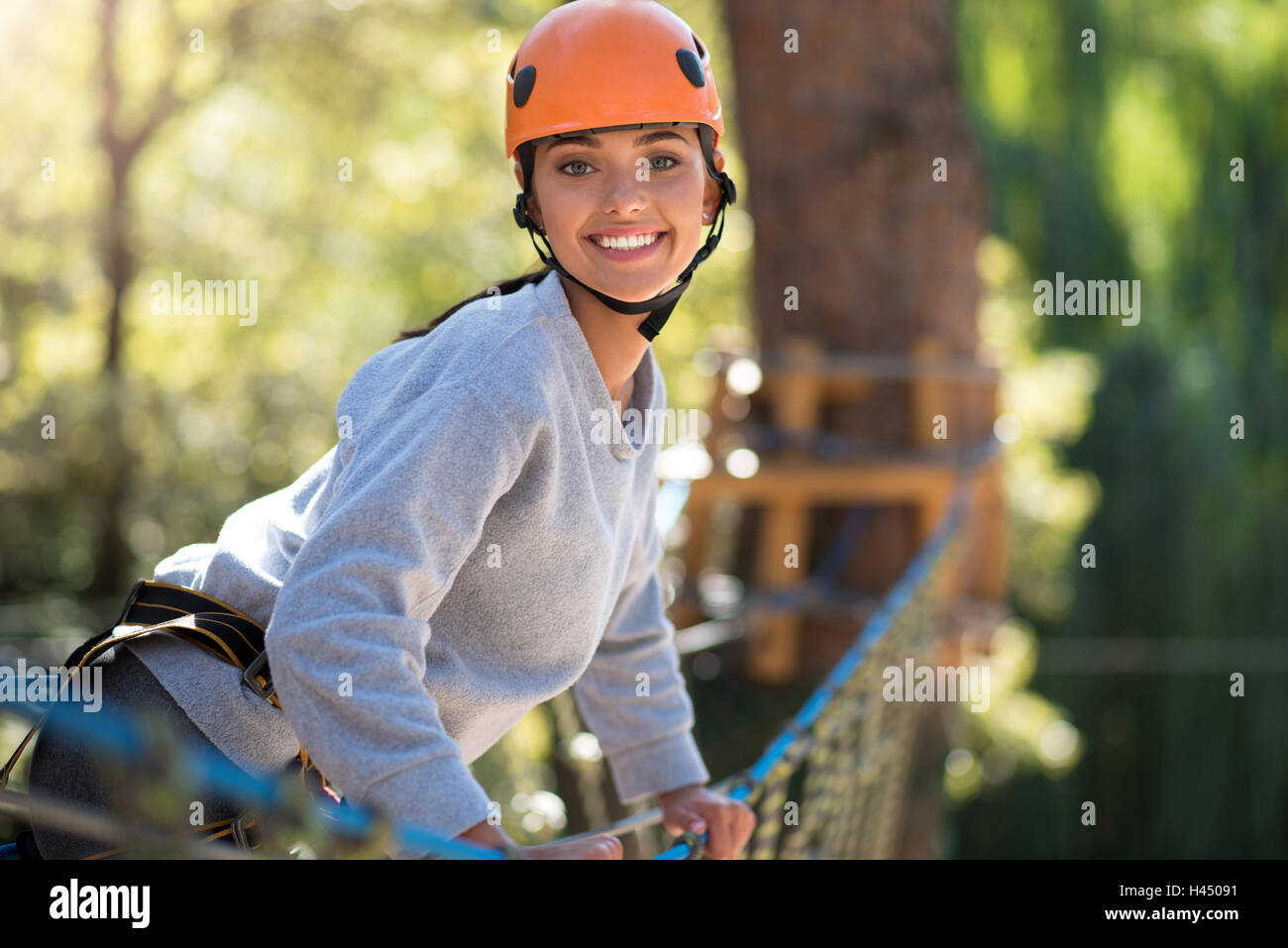 Confident happy woman leaning forwards Stock Photo