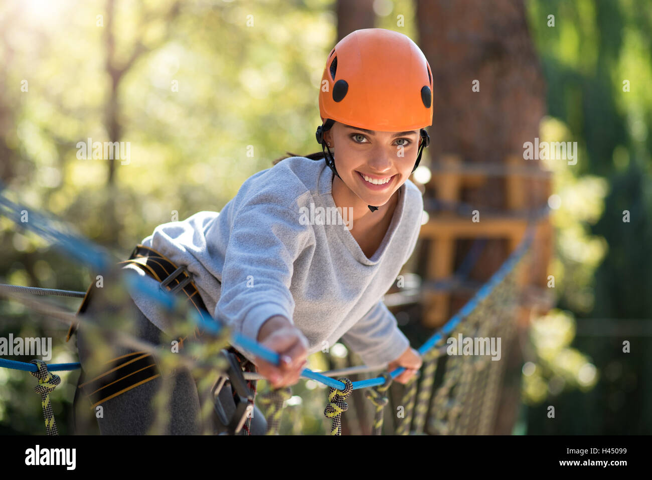 Positive emotional woman standing on the rope road Stock Photo
