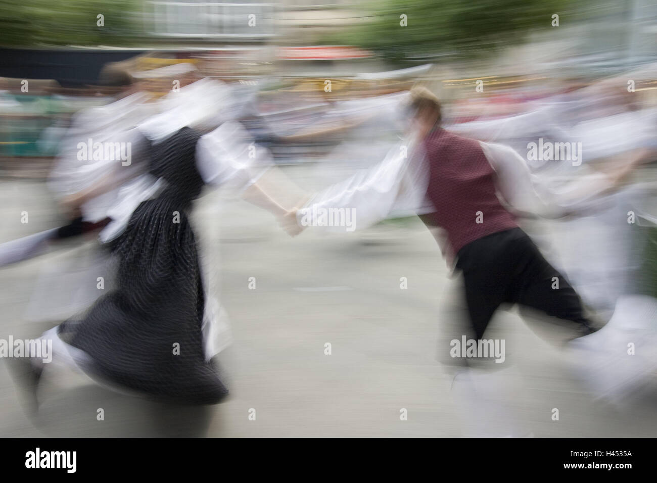 Germany, Hannover, shopping street, dance group, national costume dance, zoomed, town, dance feast, feast, dance, folk dance, dance couple, couple, back view, person, group, folk dance, national costume, dance, folklore, motion, zoom recording, zoom effect, motion blur, Stock Photo