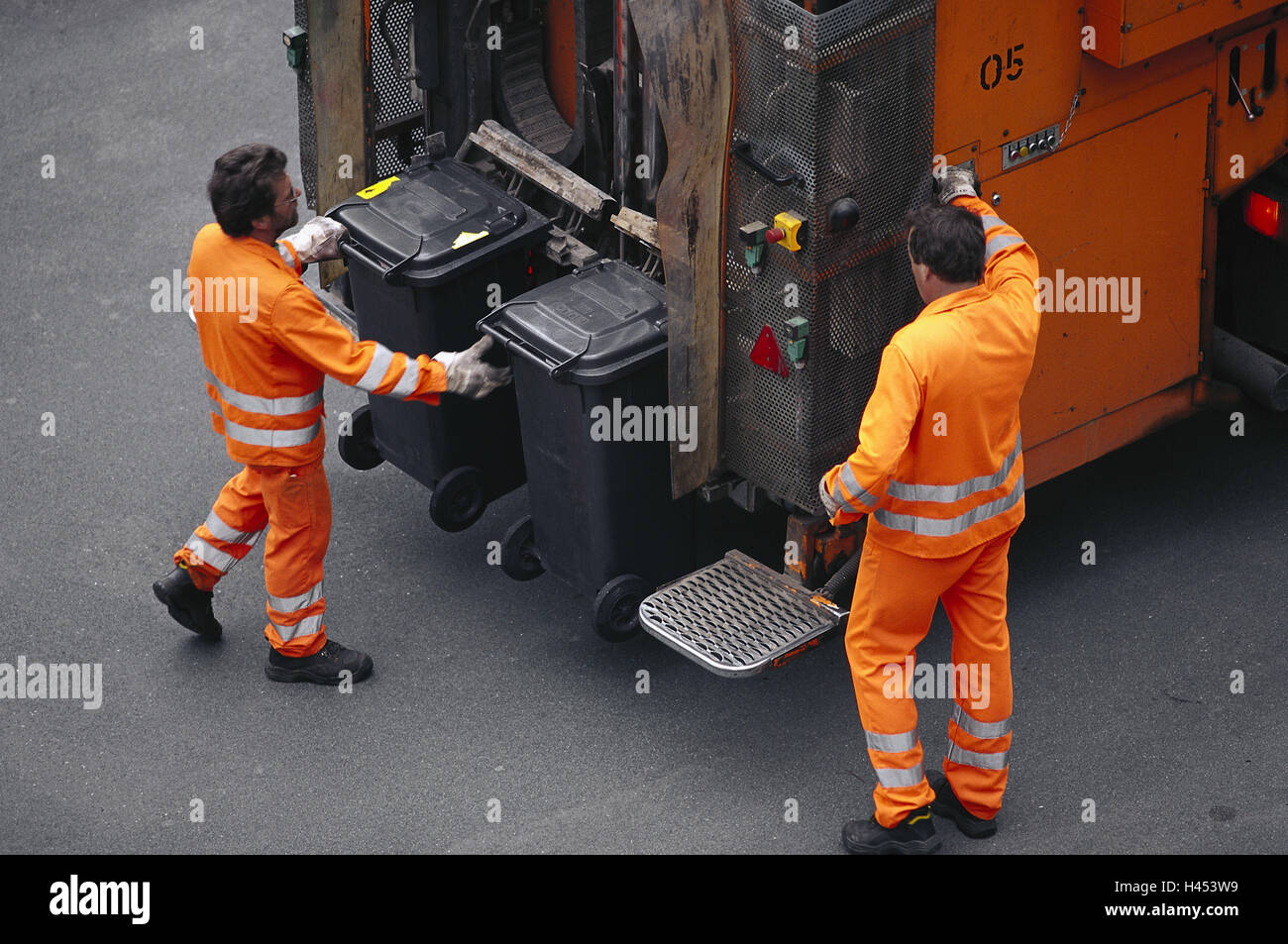 Germany, garbage collection, men, bins, emptying, garbage truck, detail, rear, garbage disposal company, disposal company, service, waste disposal, waste industry, people, garbage collectors, two, flush, empty, occupation, work, garbage bins, domestic waste bins, disposal, removal, waste, garbage, domestic waste, residual waste, vehicle, truck, special vehicle, garbage truck, bin lorry, rear loader, cleaning, protective clothing, luminous colours, orange, reflecting, Stock Photo