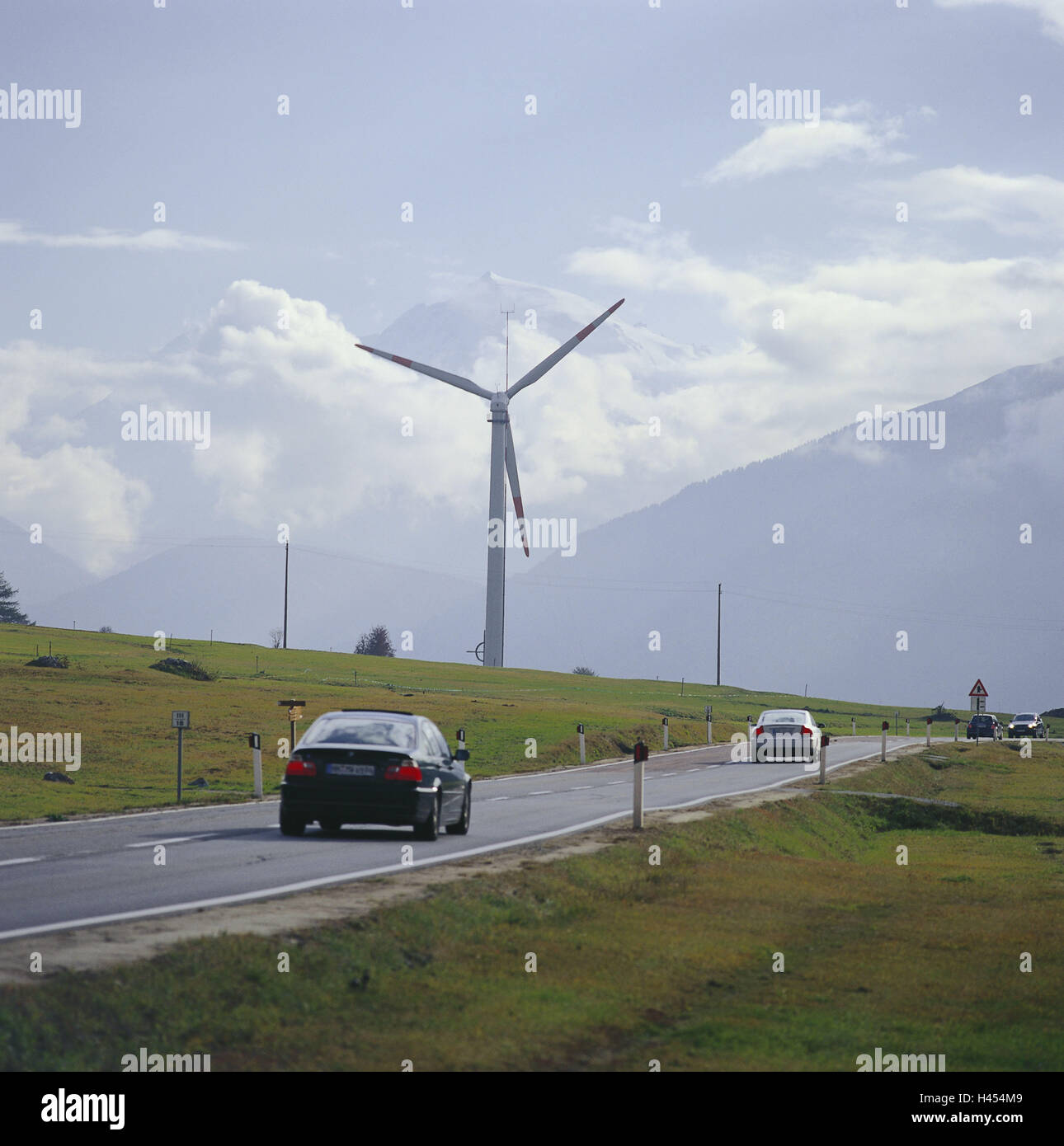 Italy, South Tyrol, crisp pass, street, traffic, wind turbine, mountain, Ortler, mountain pass, holiday traffic, cars, Pkw's, heavens, clouds, hazy, cloudily, wind power, energy, wind power, current production, alternatively, renewable, climate protection, Stock Photo
