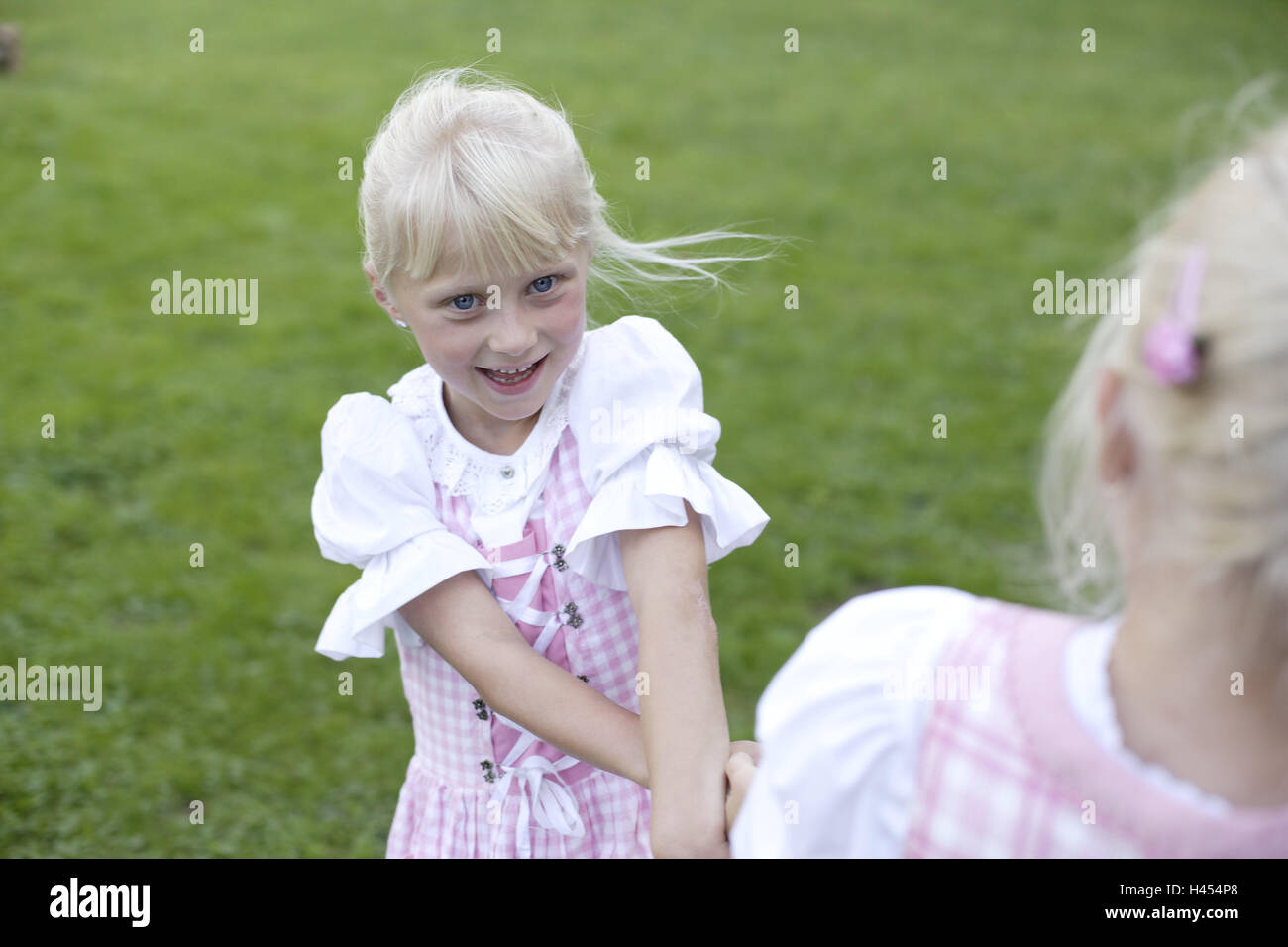 Meadow, girl, two, dirndls, play, wooden hut, hut, alpine hut, alp, person, children, sisters, siblings, blond, friends, national costume, clothes, checked, pink, joy, fun, happy, melted, dance, circle, rotate, smile, there stand, naturalness, childhood, summers, holidays, Stock Photo