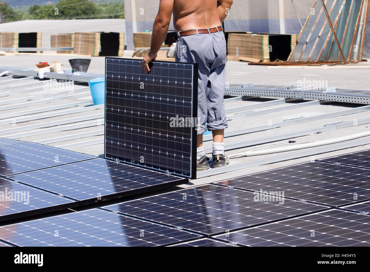 skilled worker fitting a photovoltaic panel on a roof Stock Photo Alamy