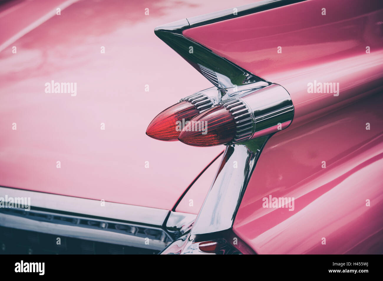 Pink Cadillac. Sharp tail fin with dual bullet tail lights. Vintage