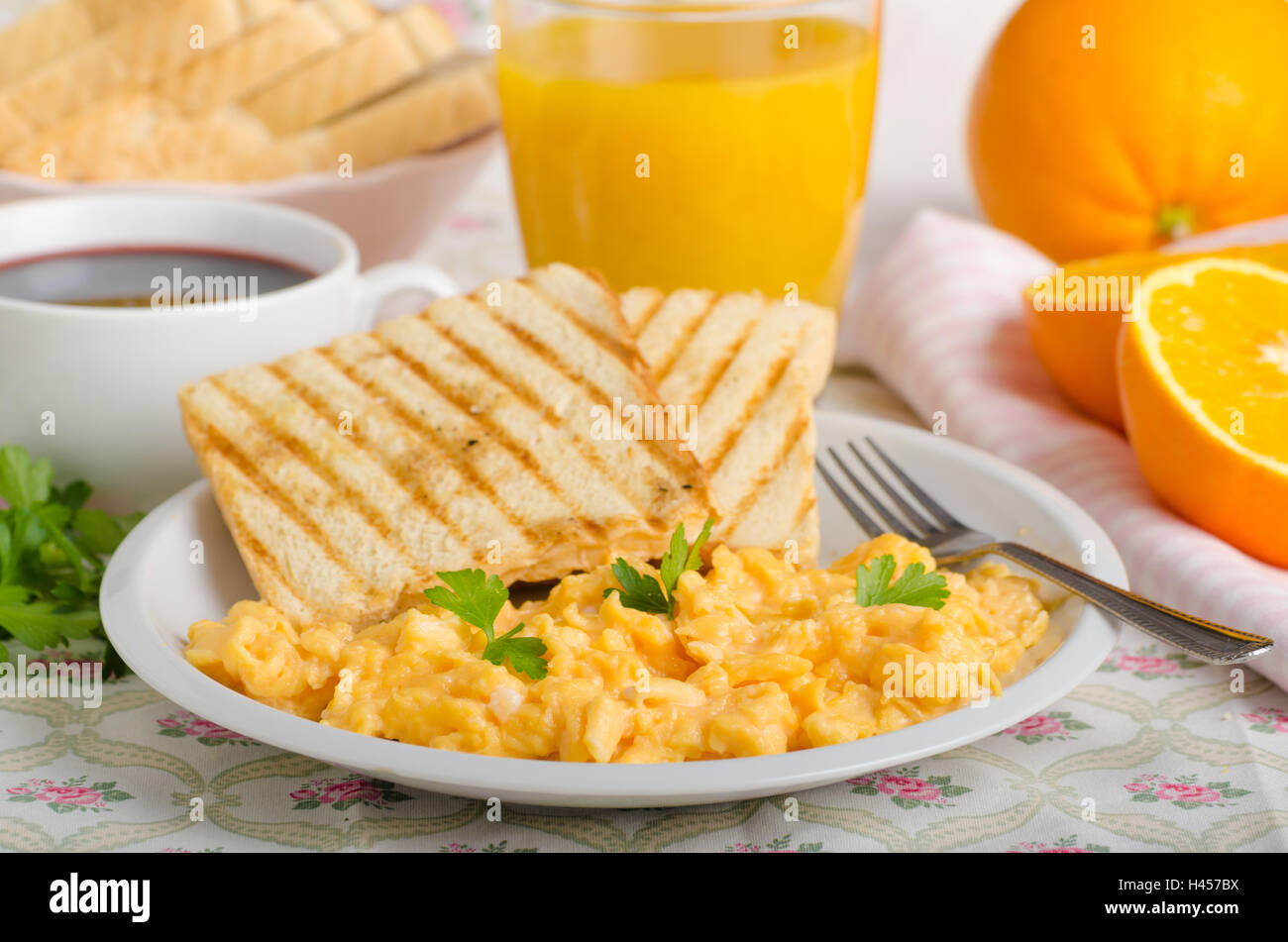 Breakfast, scrambled eggs, french toast, fresh juice, coffee Stock