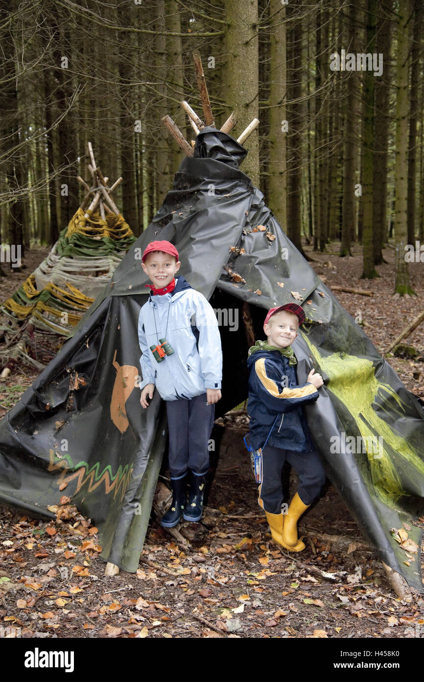 Two boys, 6 and 7 years, brothers, in the wood, in a tent, model released, Stock Photo