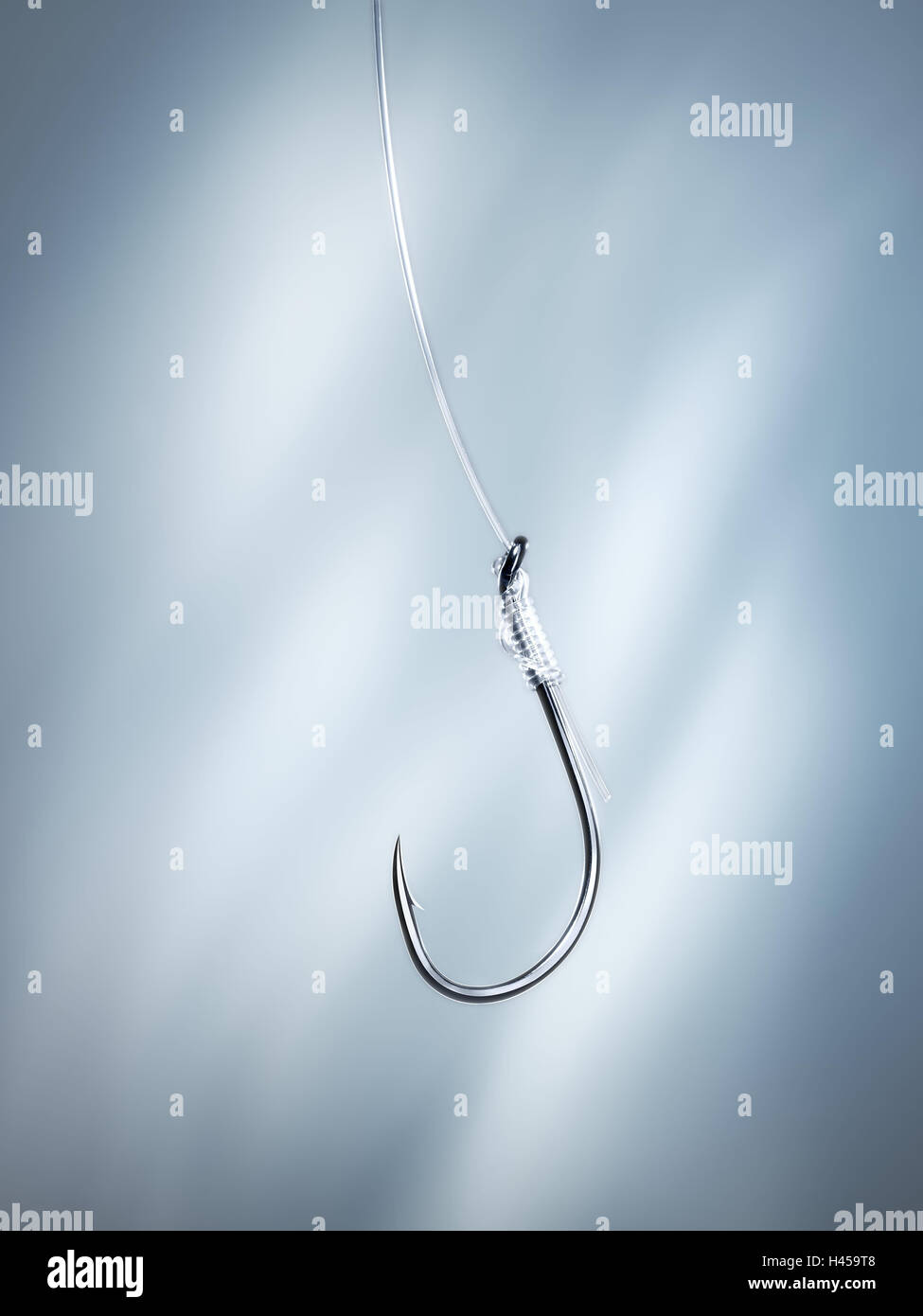 Fishhooks, cable, background, blue, hooks, fishing line, fish, angling,  pointed, trap, fishing, metal, light, studio Stock Photo - Alamy
