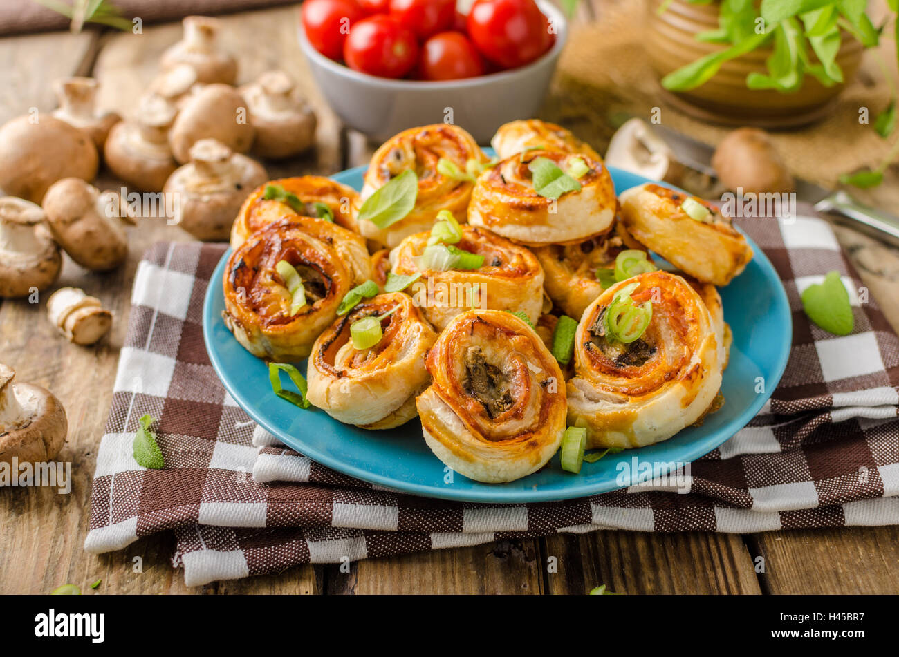 Pizza snails in puff pastry with ham, cheese and mushrooms Stock Photo