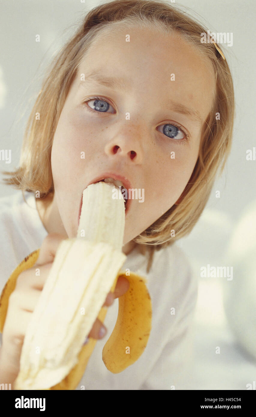 child eating banana