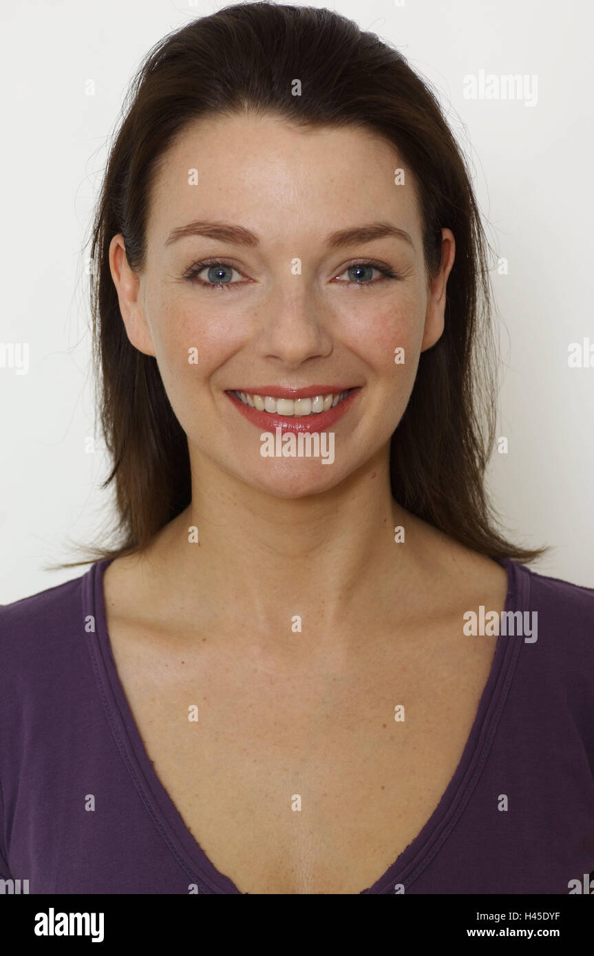 Woman, smile young, view camera, portrait, studio, person, stand, T-shirt, mauve, V-comb, cogs, blue-eyed, brunette, calmness, happily, friendly, contently, happily, head-on, vertical format, Stock Photo