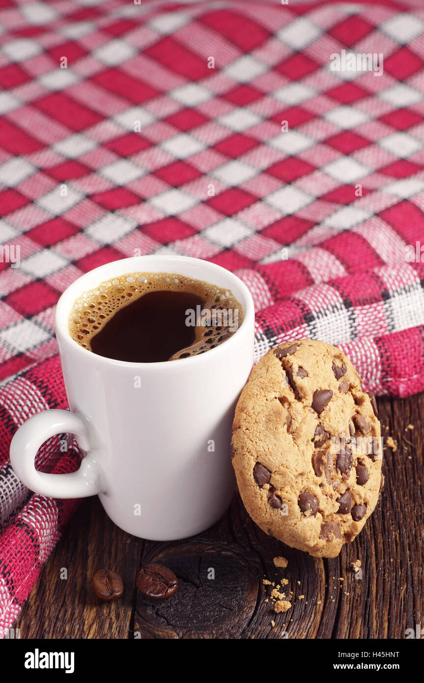 Cookie with chocolate and cup of hot coffee on wooden table covert tablecloth Stock Photo