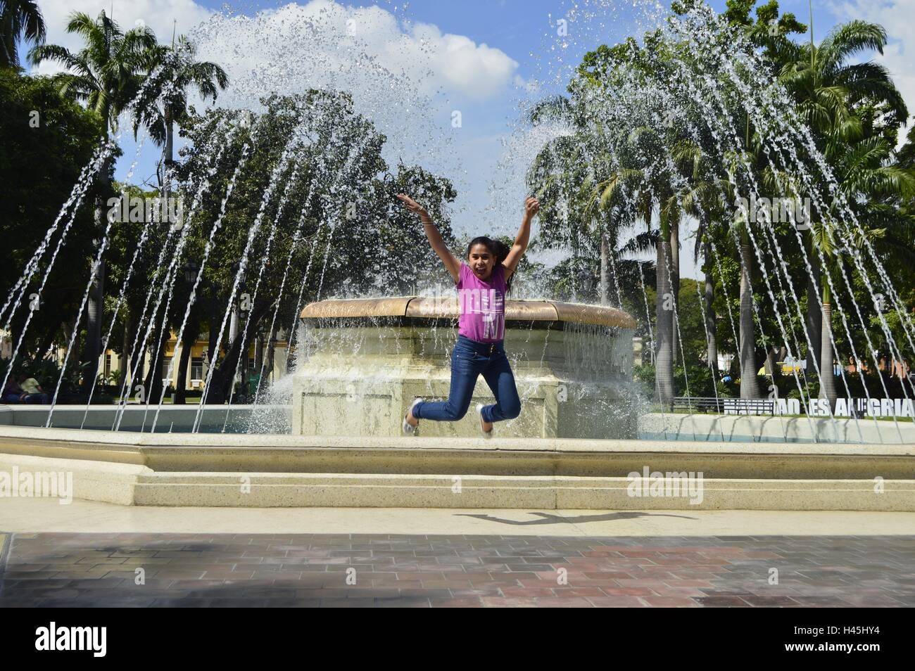 Girl jump of happiness in Bolivar Square Stock Photo
