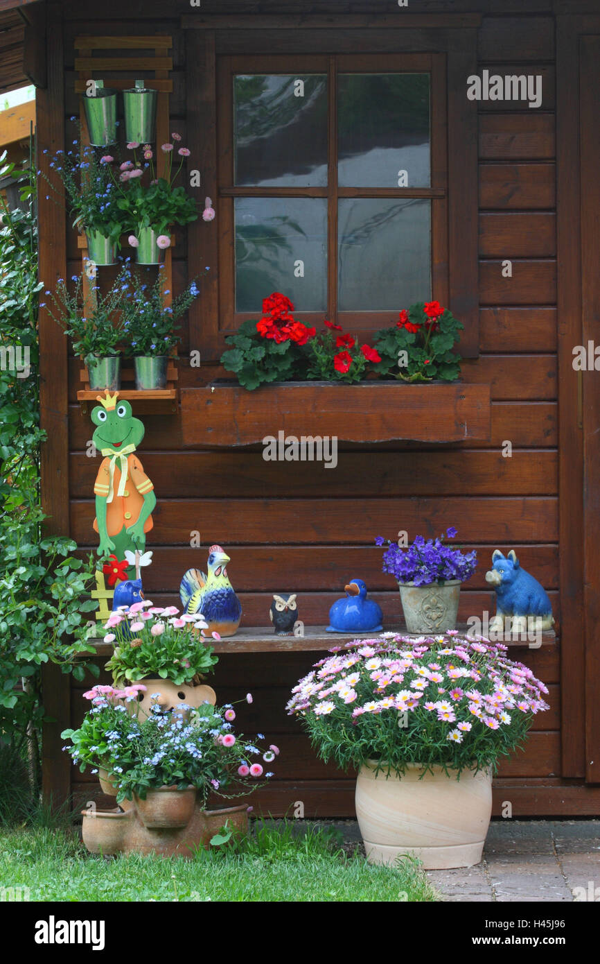 Summer house with flowers and garden figures Stock Photo - Alamy