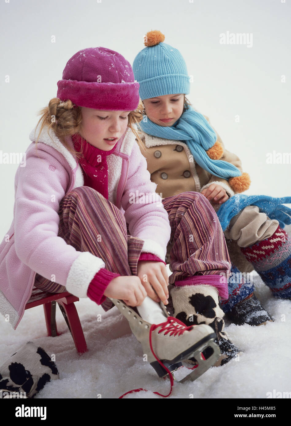 Girls, ice skates, boy, accelerate, watch, sit, sleigh, winter, Stock Photo