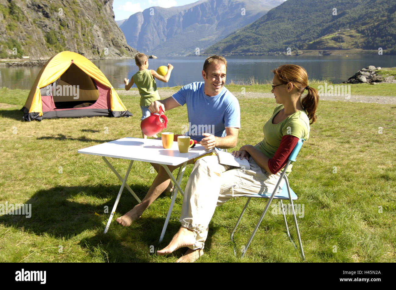 Norway, mountain lake, shore, family, camping, cheerfully, series, mountain scenery, lake, fjord, fjord-country, Aurlandsfjord, people, child, plays camping boy, ball, parents, camping-table folding chairs laughs, joy, happily, fun joy adventures leisure time vacation, vacation, family-vacation, family-trip, family-luck, family-lives, harmony, camping-vacation, Stock Photo