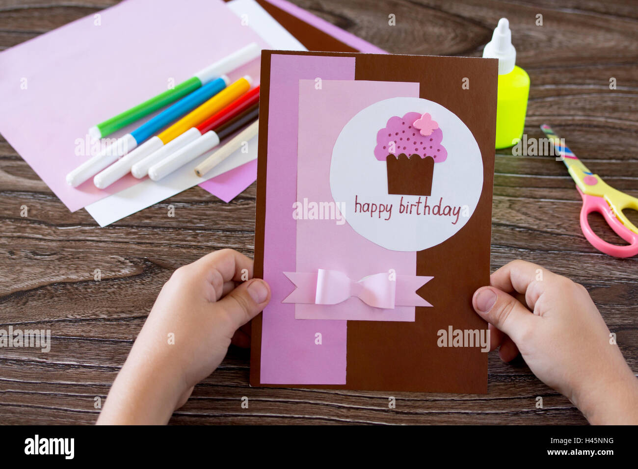The child holds a birthday card handmade birthday inscription is ...