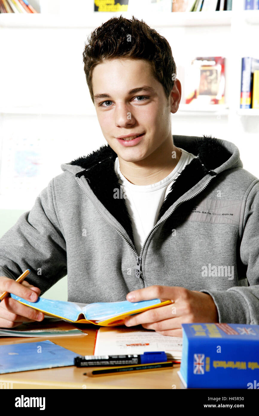 Schoolboys, boy, learn, sit, smile, table, classroom, half portrait, happy, assignment, lexicon, pens, English, Duden, foreign language, school desk, training aid, dictionary, inside, boy, concentration, teenager, youth, young person, education, scroll, r Stock Photo