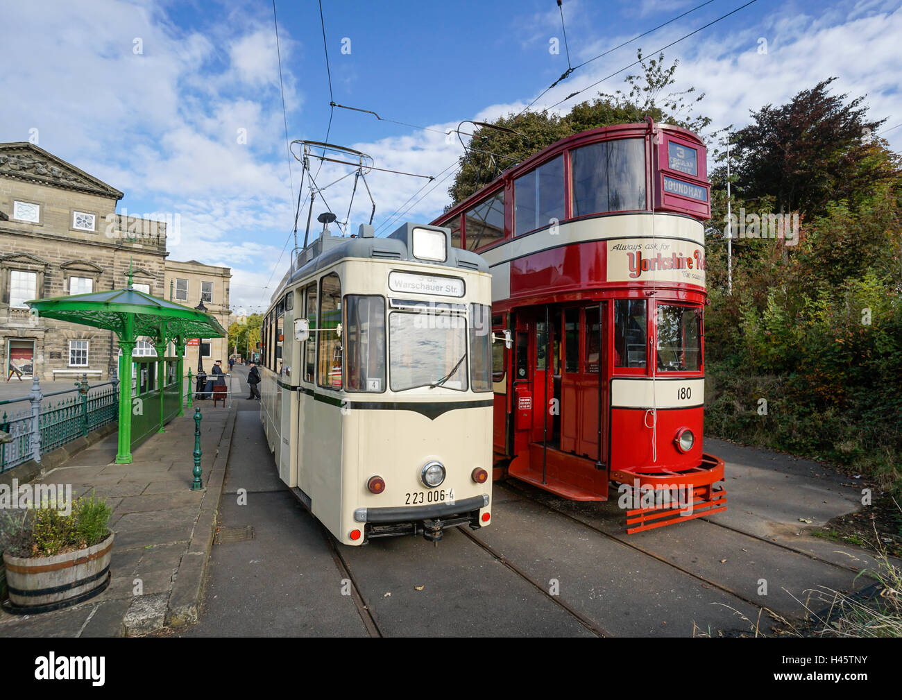 Trams at Town End Terminus at Crich Tramway Village  Crich Matlock Derbyshire England with Derby Assembly Rooms left Stock Photo