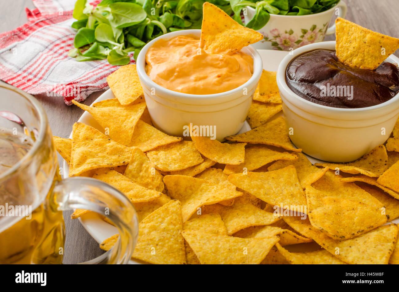 Tortilla chips with cheese dip and barbecue, czech beer Stock Photo Alamy