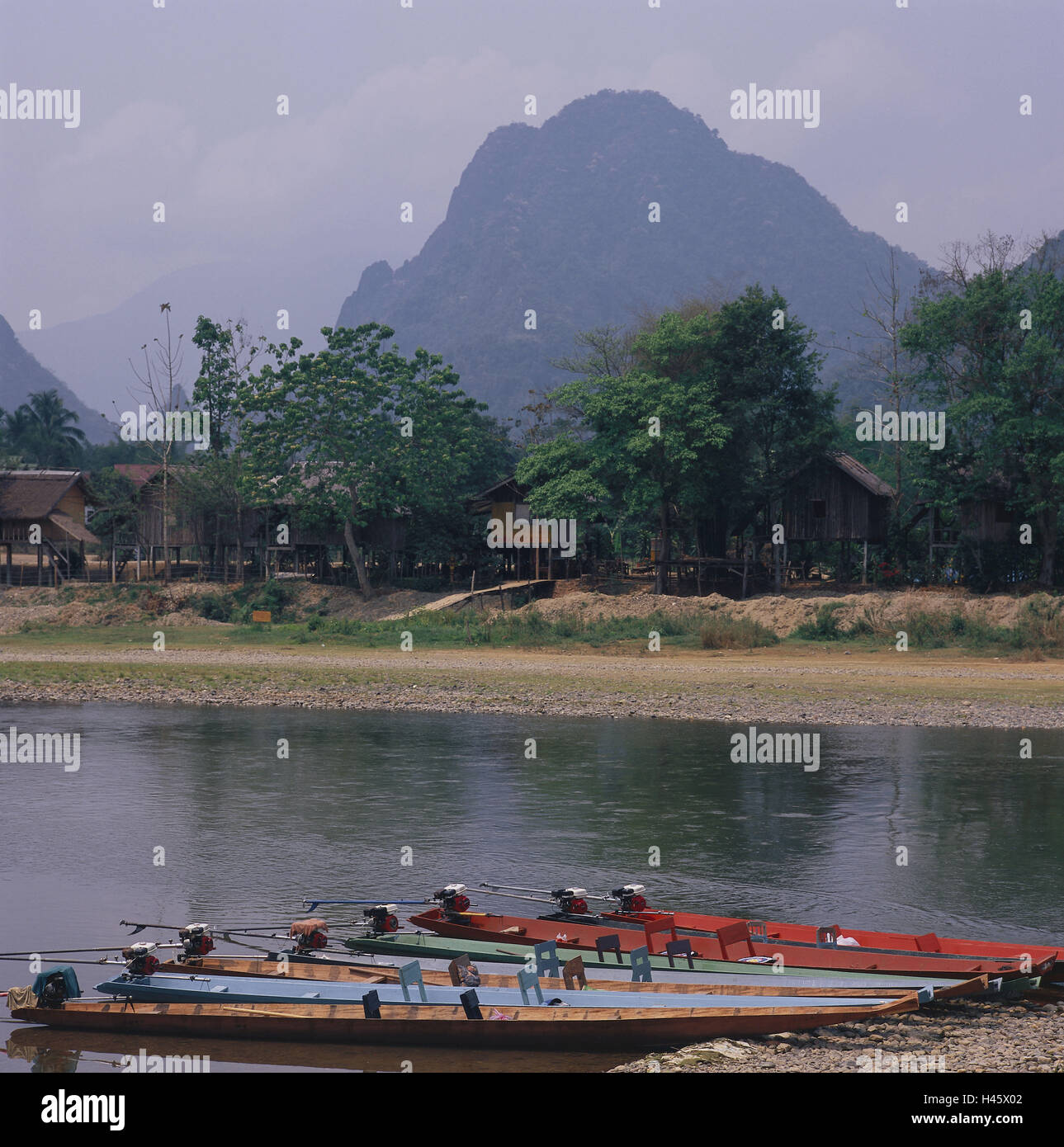 Laos, Vang Vieng, river Nam Song, shore, boots, Asia, South-East Asia, destination, tourism, background, mountains, limestone rocks, riversides, wooden boots, hut, houses, building on stilts, trees, Stock Photo