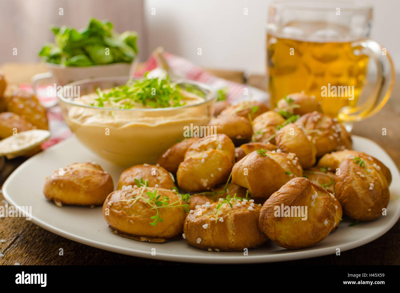Pretzel rolls homemade, cheese dip from cheddar with beer and mustard