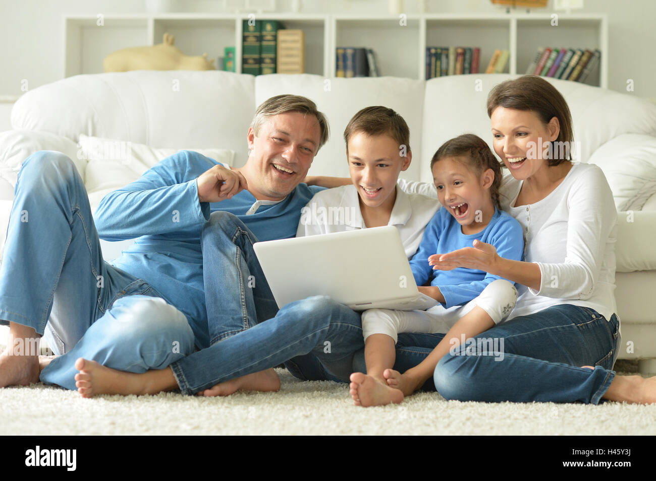 family at home with laptop Stock Photo - Alamy