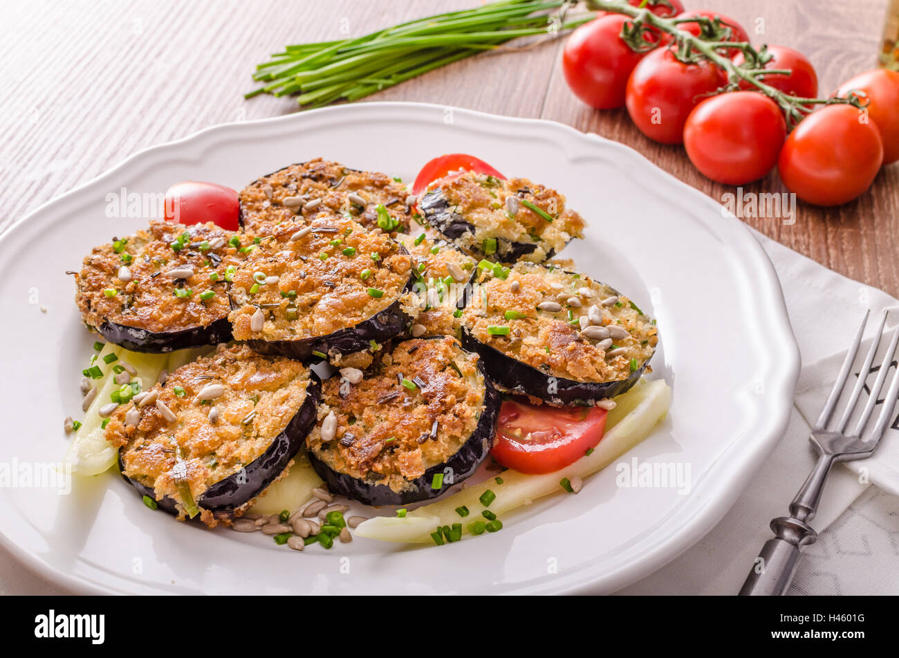 Fried zucchini breaded, with simple vegetable salad, sprinkled herbs Stock Photo