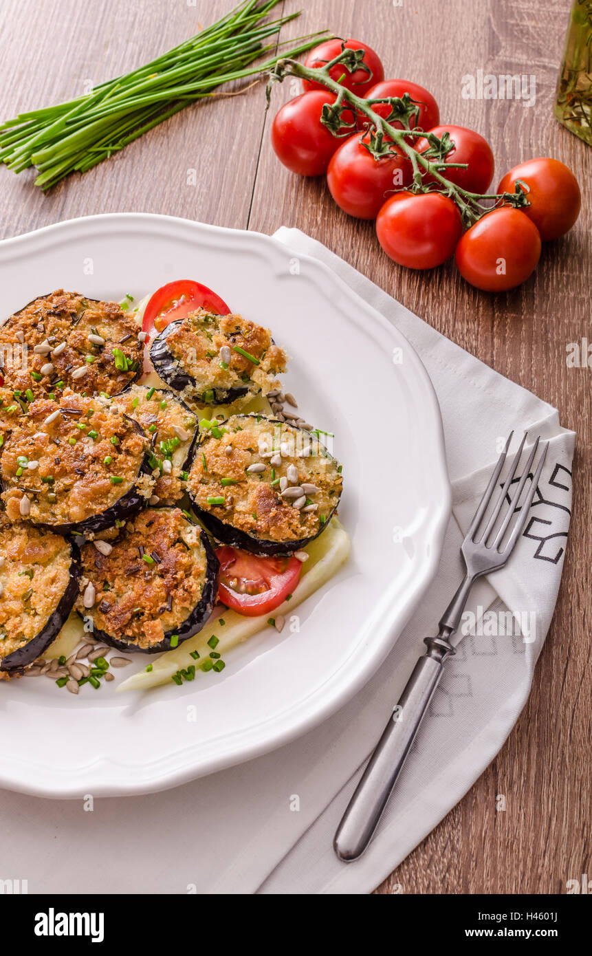 Fried zucchini breaded, with simple vegetable salad, sprinkled herbs Stock Photo