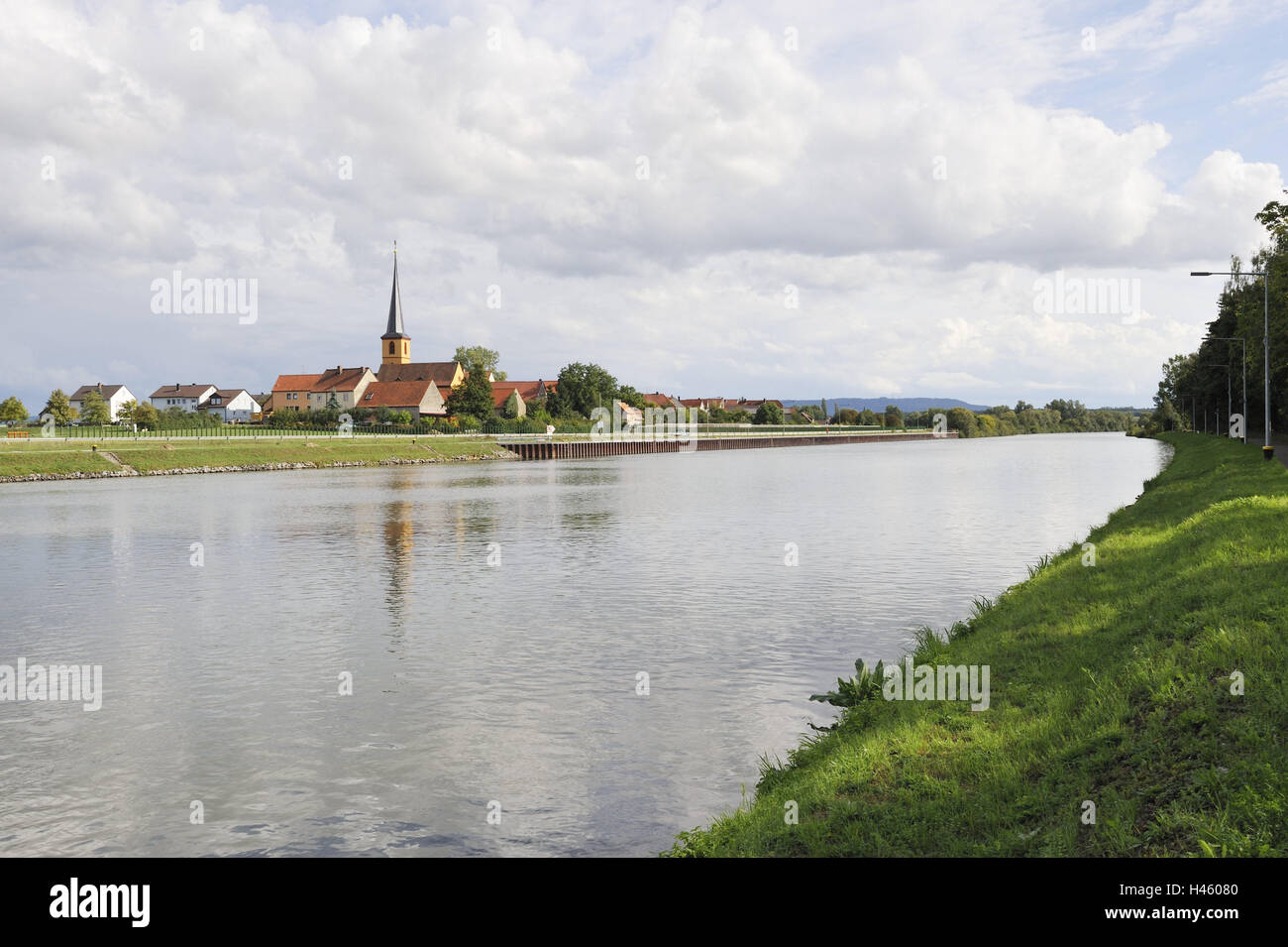 Germany, Bavaria, Gerlachshausen., village view, Main channel, Lower Franconia, village, church, steeple, Christianity, religion, faith, church, houses, residential houses, culture, landmark, water, channel, water way, landing stage, ship traffic, cloudy sky, Stock Photo