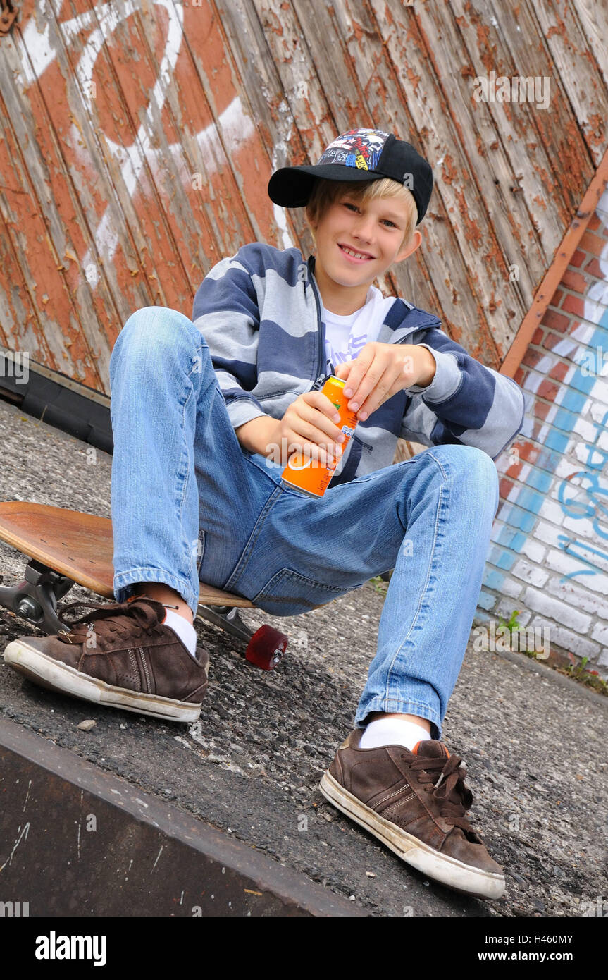 Boy, baseball cap, drinks can, skateboard, sit, view camera, kids, young persons, playing skat, skaters, cap, break, happily, Longboard, smile, open lighthearted, childhood, youth, cap, outfit, carelessly, youth culture, cleverly, mischievously, industrial scales, leisure time, outside, industrial area, graffiti, Sneakers, jeans, thirst, drink, tin, break, lemonade, drink, Stock Photo