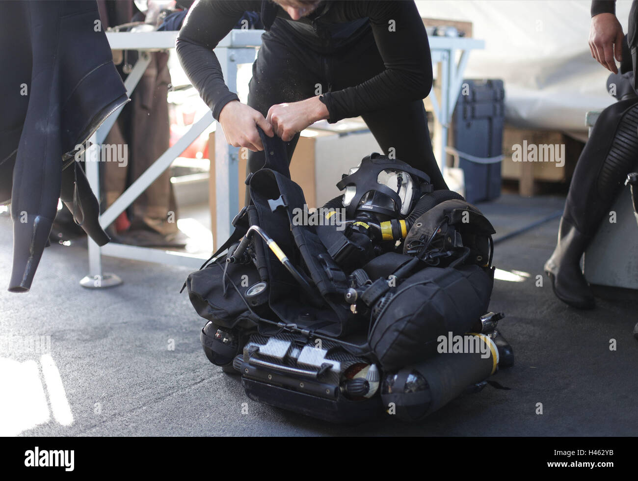 A diver checking his CDLSE (Clearance Divers Life Support Equipment) mixed gas diving kit on board HMS Cattistock - a Royal Navy Hunt-class mine countermeasures vessel - in the Lochs of western Scotland, during a Royal Navy Joint Warrior training exercise. Stock Photo