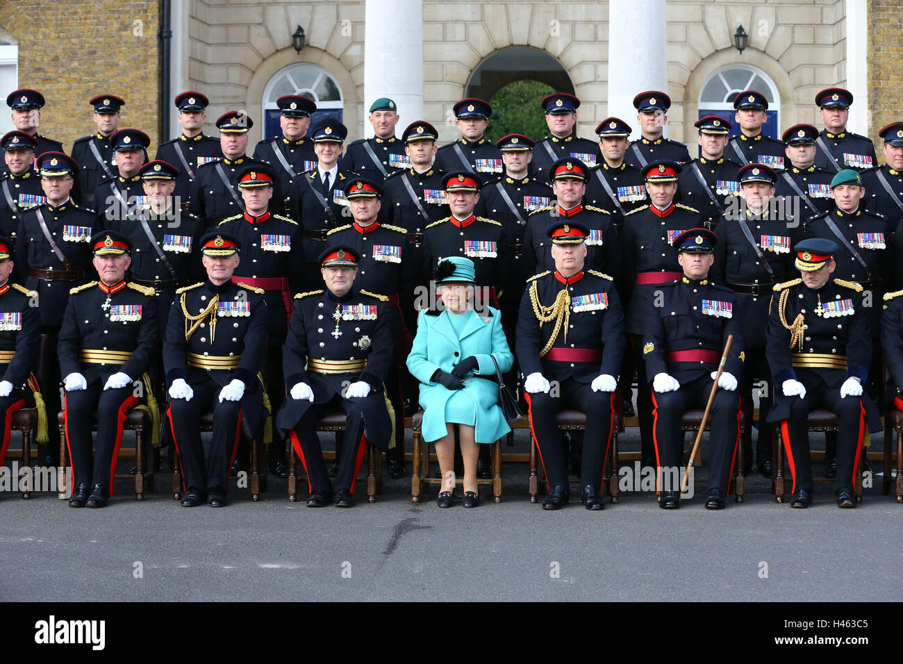 Queen Elizabeth II poses for a group photograph during a visit to the Corps of Royal Engineers at Brompton Barracks in Chatham, Kent, to celebrate their 300th anniversary. Stock Photo
