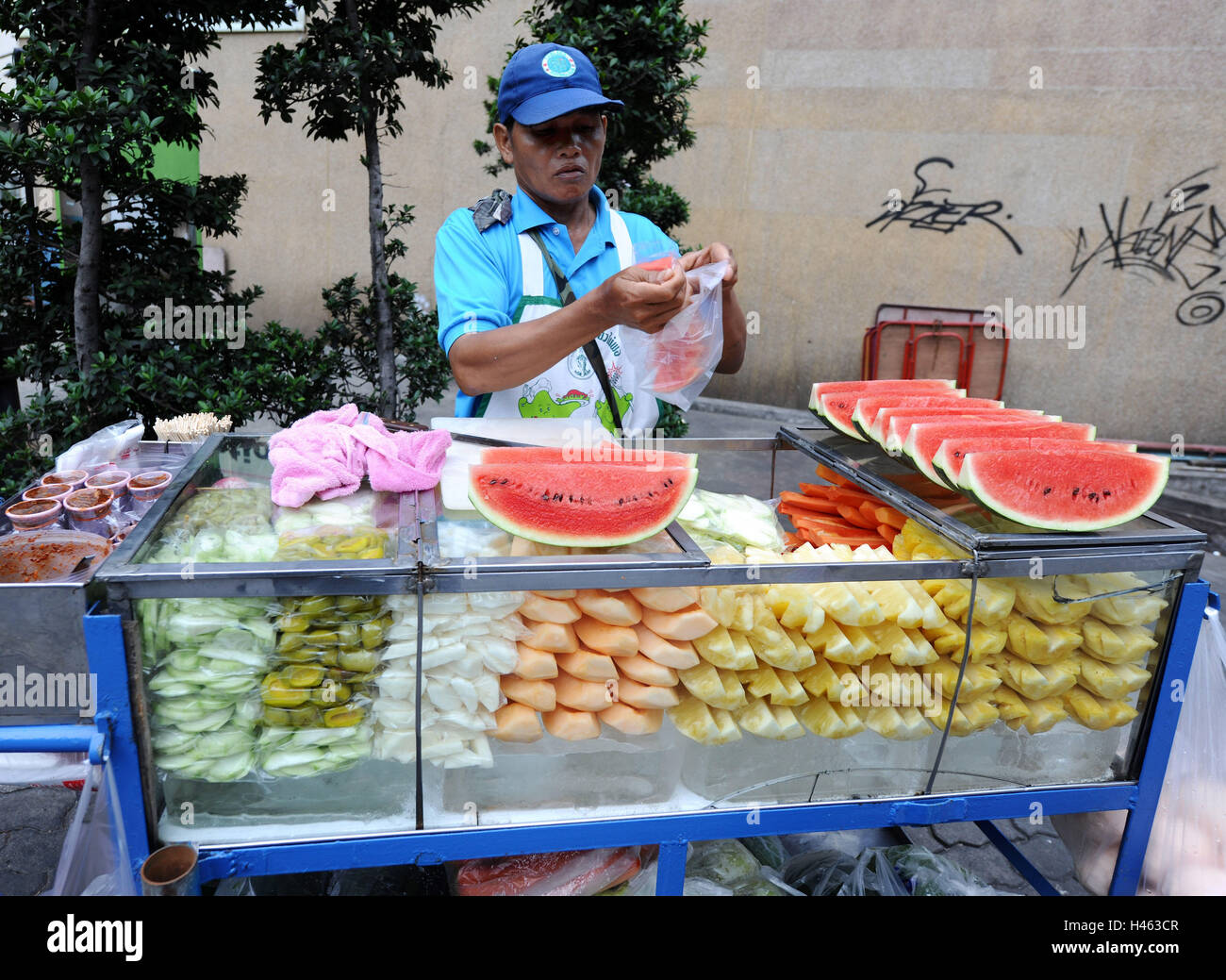 Thailand, local, fruits, sales, man, person, fruit, freshly, sell, melons, pineapple, bottle, sales booth, occupation, seller, work, headgear, sign cap, cap, Stock Photo