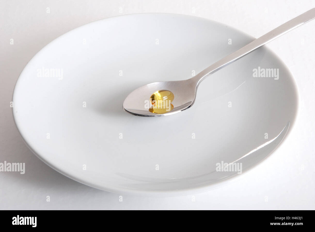 Plates, spoons, omega tablets, the pill, tablet, capsule, health, taking, mania, food supplement means, porcelain, dependence, drug, swallow, hypovitaminosis, mangle manifestation, Stock Photo