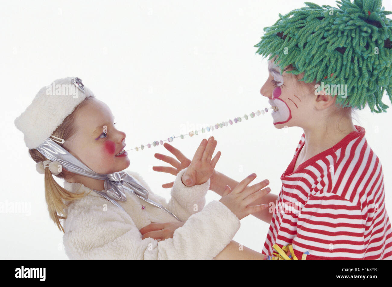 Carnival, children, two, disguise, costumes, clown, ice princess, candy chain, eating, sharing, opposite, Stock Photo