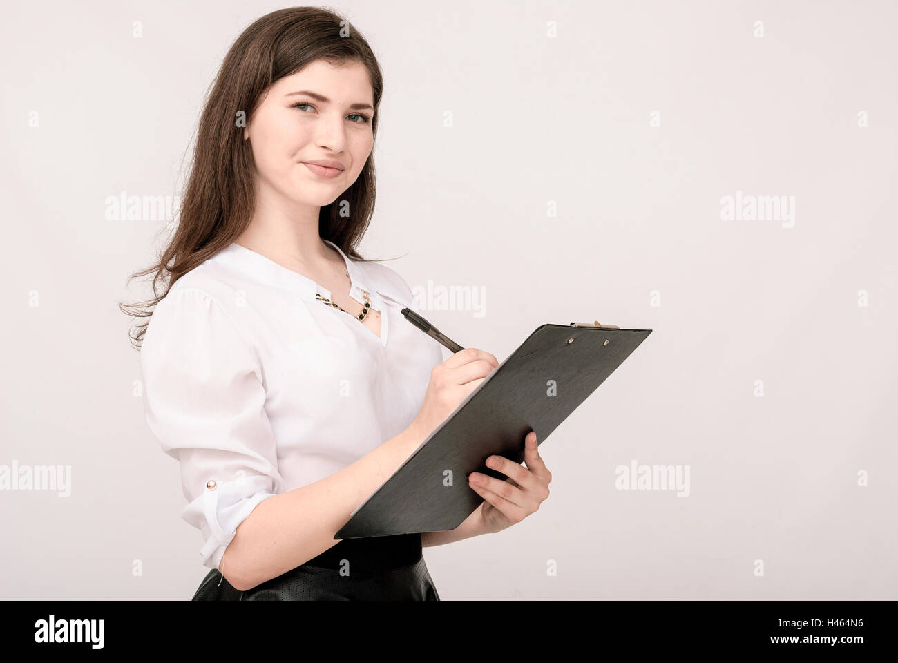 Portrait of smiling business woman with paper folder Stock Photo - Alamy