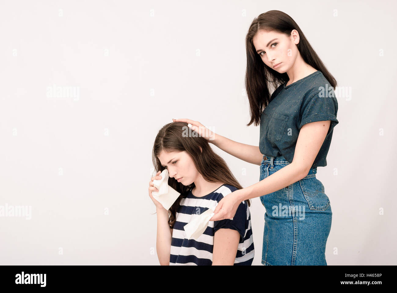 Troubled young girl comforted by her friend Stock Photo - Alamy