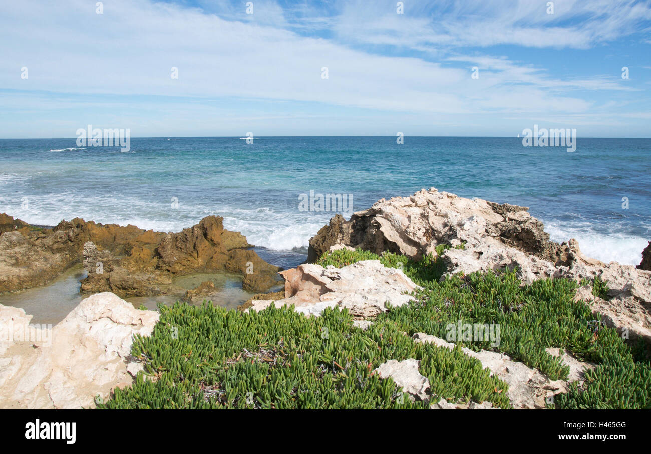Limestone rock pools with plants and the Indian Ocean seascape at ...