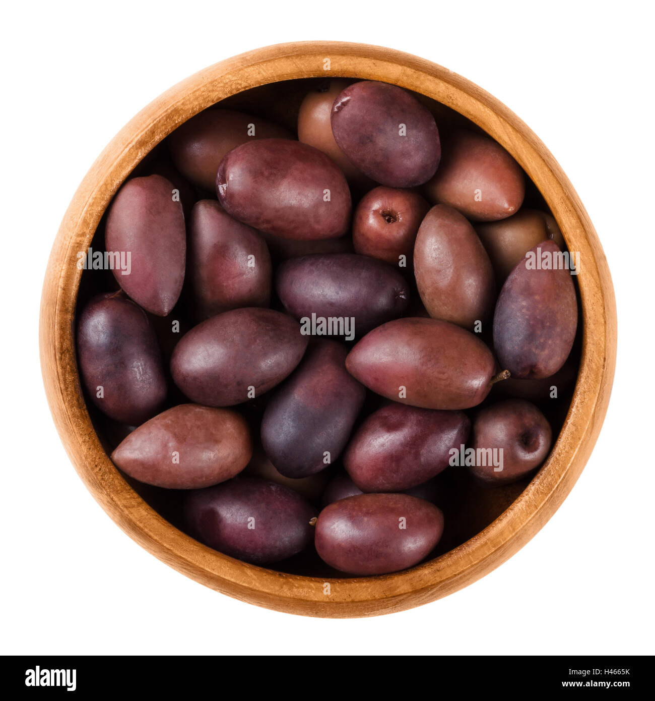 Kalamata black olives in a wooden bowl over white. Greek large purple table olives. A variety are called Kalamon olives. Stock Photo