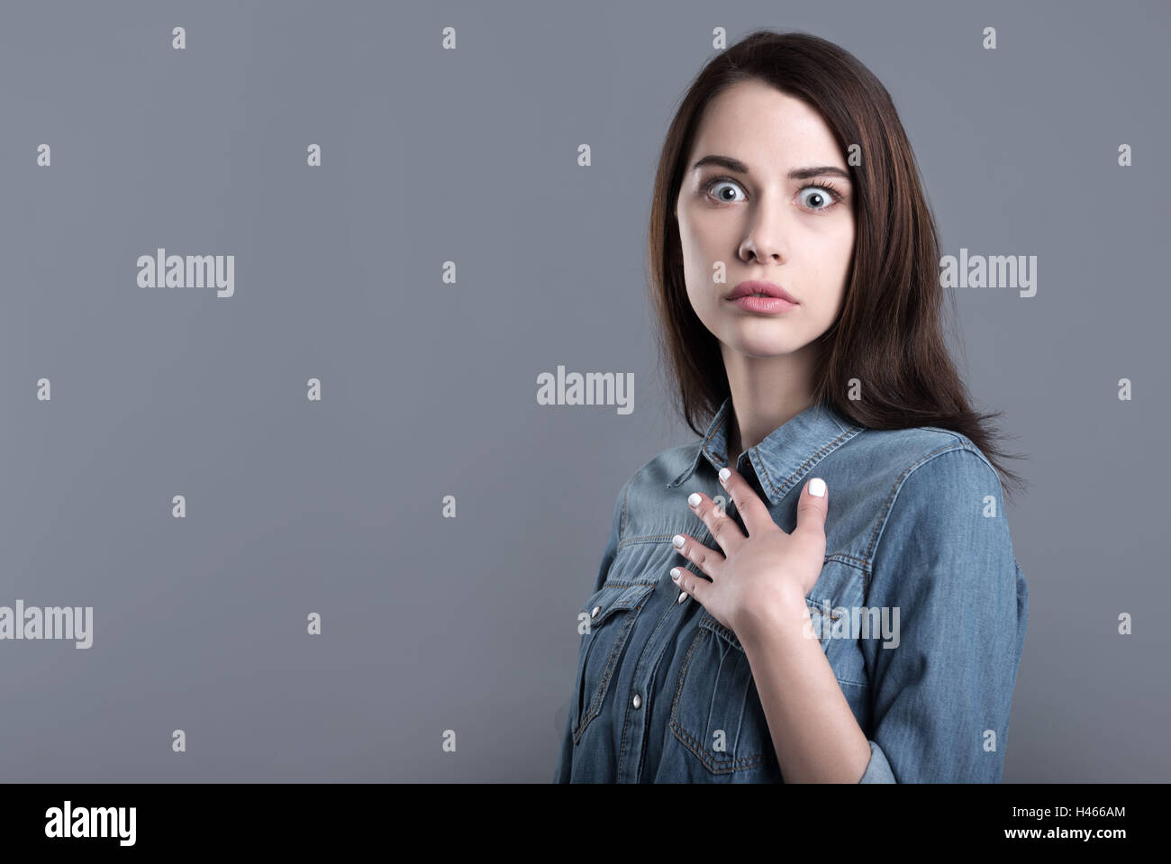 Surprised and confused young woman Stock Photo