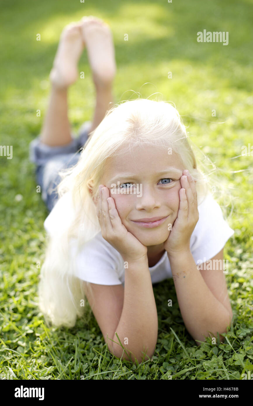 Girls, meadow, lie, rest view camera, people, child, abdomen, abdominal position, blond, view, happy, friendly, contently, lazy, take it easy, barefoot, whole body, naturalness, childhood, summer, outside, sunlight, Stock Photo