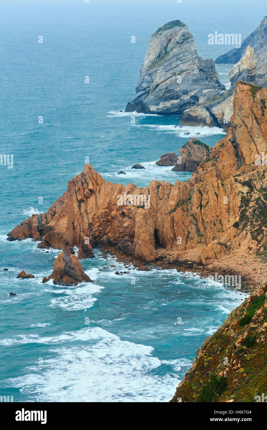 Atlantic ocean coast (granite boulders and sea cliffs) in cloudy ...