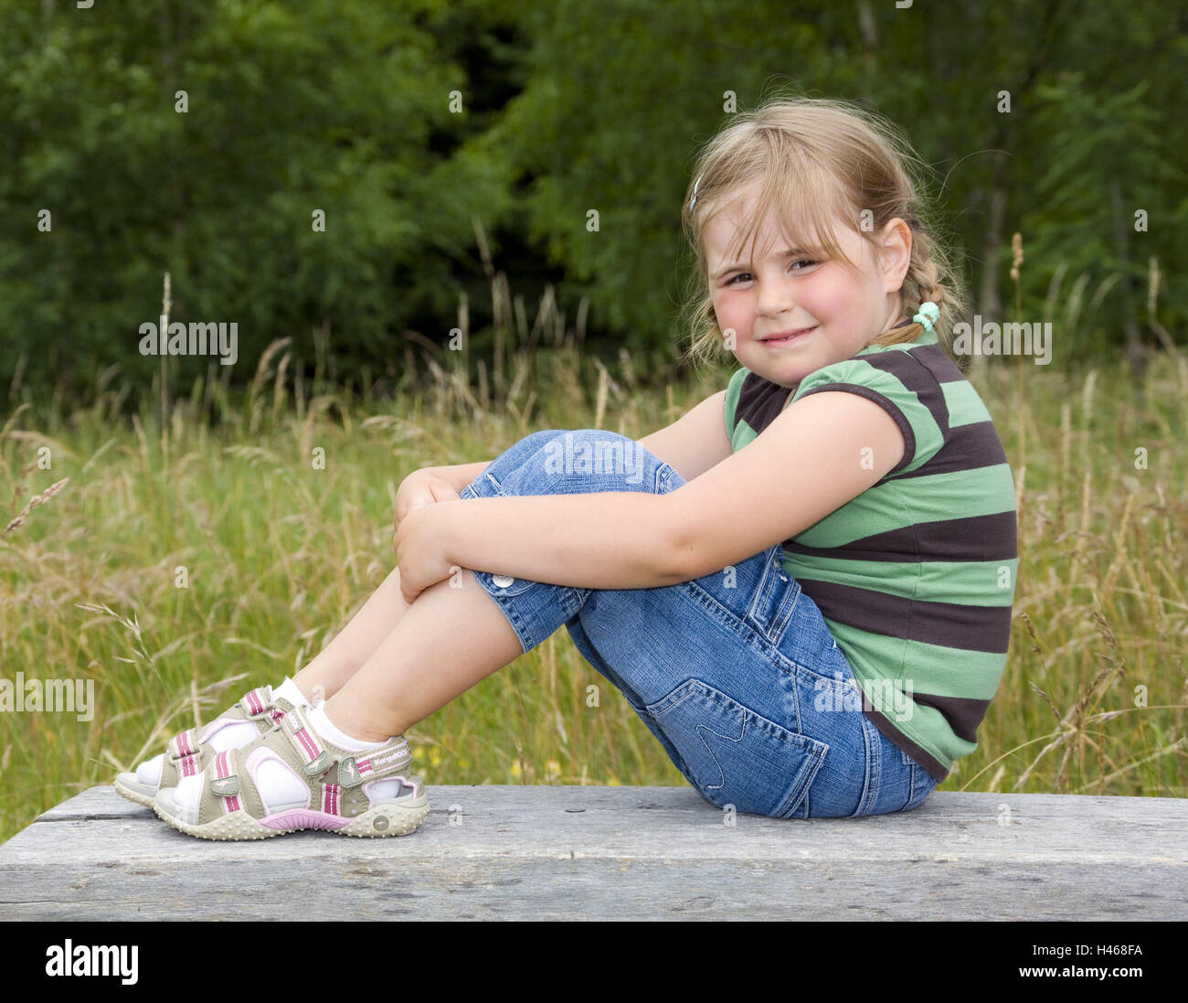 Girls, wooden bank, sit, smile side view, model released, people, child, blond, edge the forest, outside, nature, wood, grass, whole bodies, leisure time, summer, childhood, Stock Photo