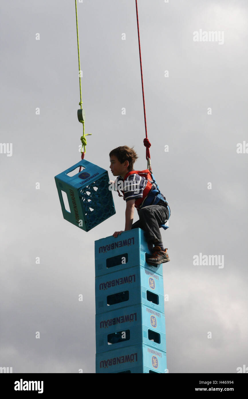Boy, climbing harness, rope, protection, beer crates, stacking, tower ...