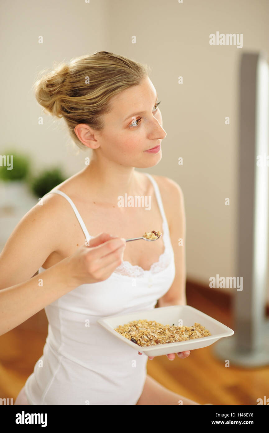 Young woman while having breakfast with cereal, Stock Photo