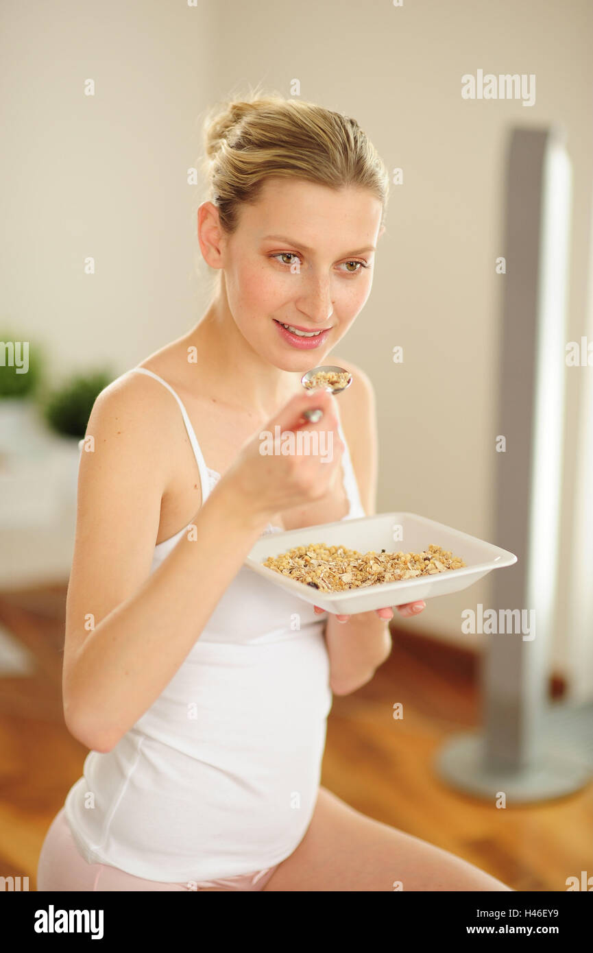 Young woman is eating muesli Stock Photo Alamy