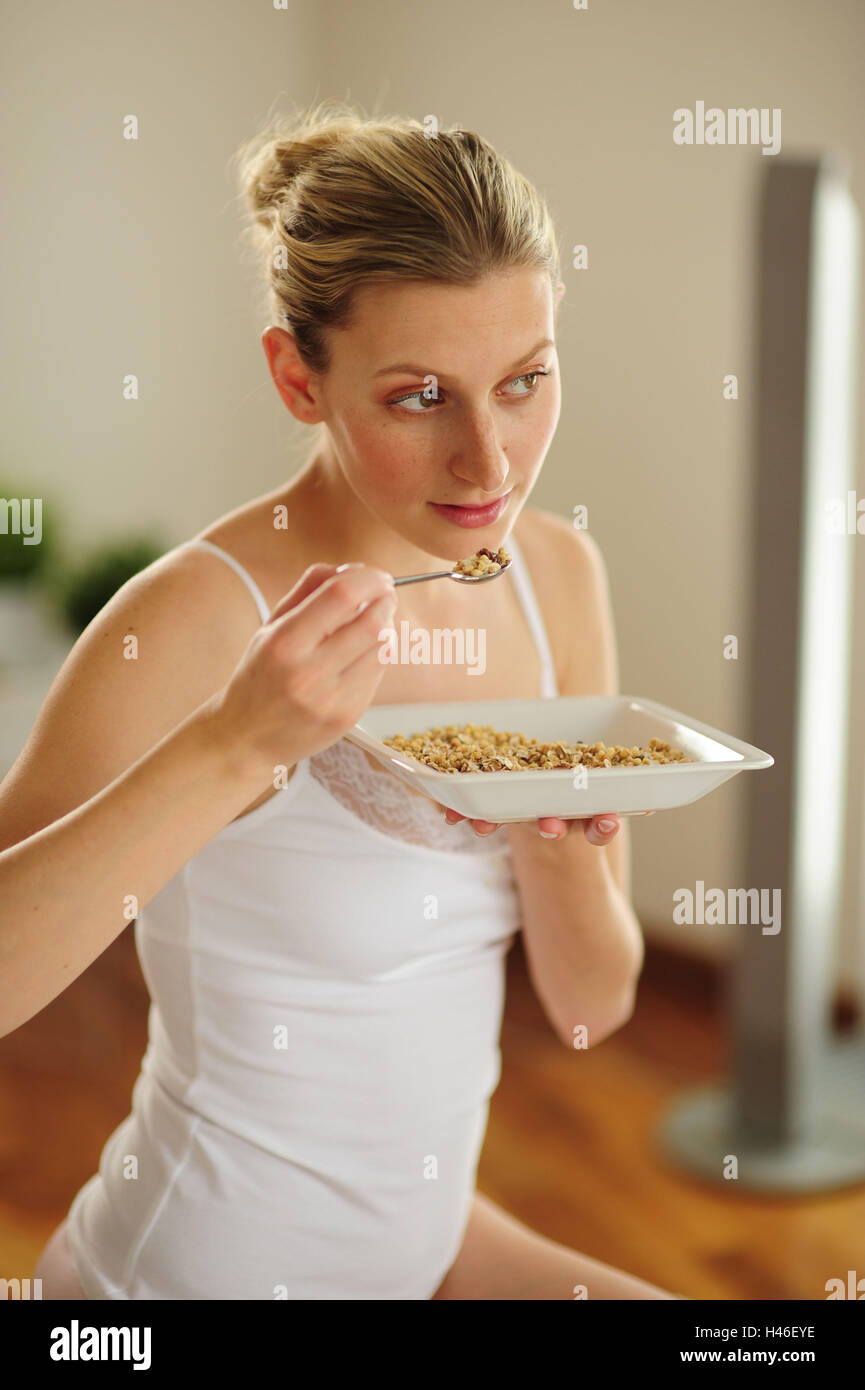 Young woman is eating muesli Stock Photo Alamy