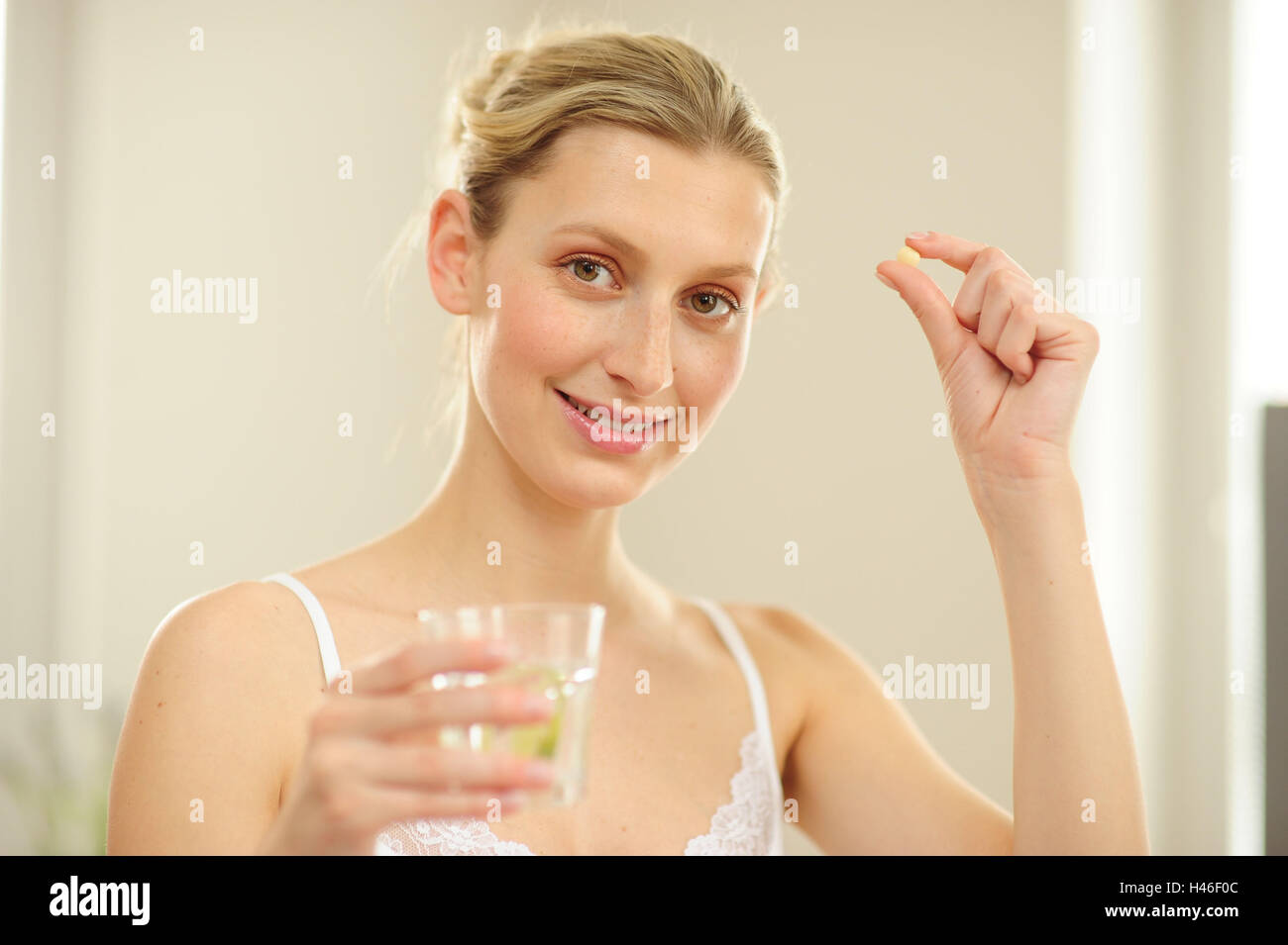 Young woman a glass of water, a tablet, Stock Photo