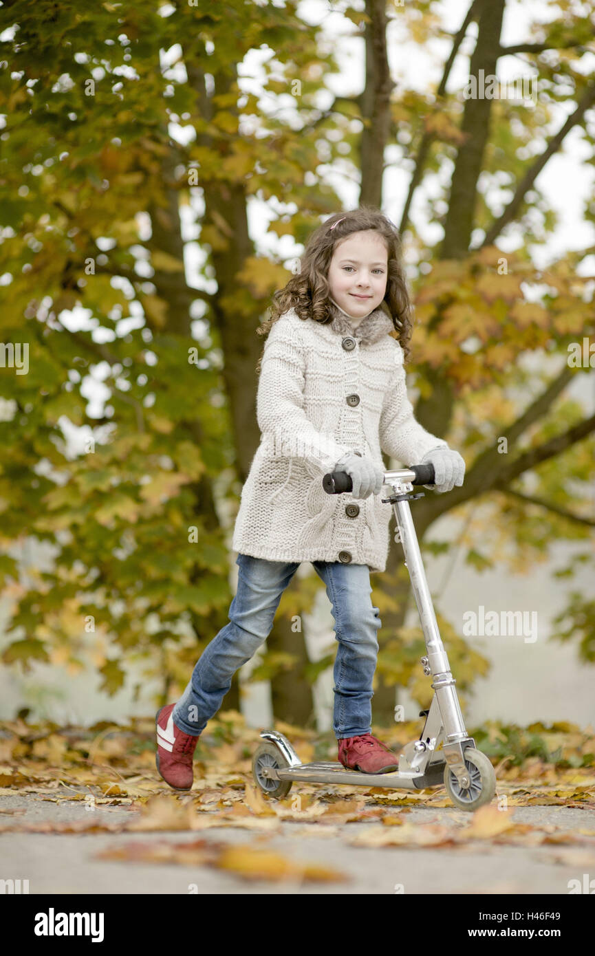 Little girl on a scooter Stock Photo Alamy
